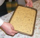 Gyümölcskenyér - A tepsi döntésével egyenlítsd ki a tészta felszínét!